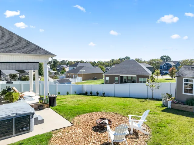 a front view of a house with garden and patio