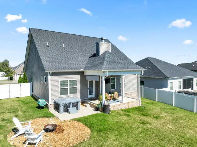 a house view with a sitting space and garden