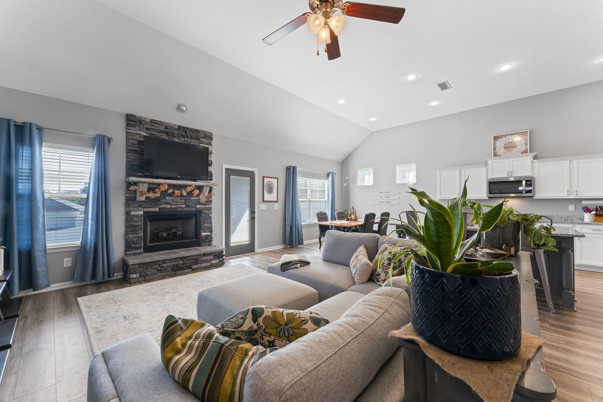 100 East Coker Way Spring Hill, TN 37174 - Photo 8 of 51 a living room with furniture a fireplace and a chandelier
