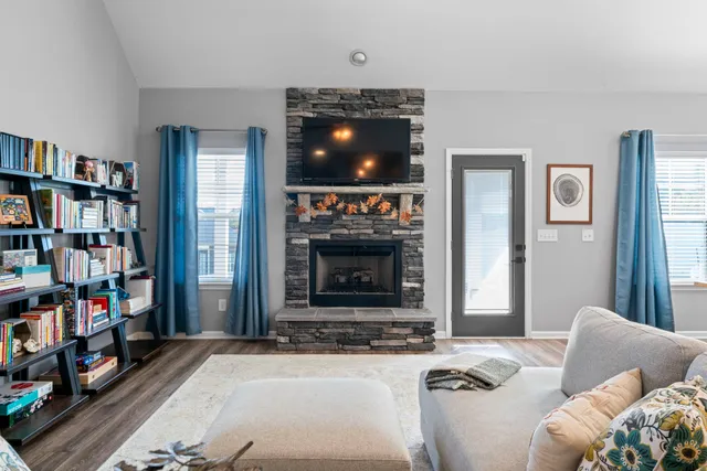 a living room with furniture a flat screen tv and a fireplace