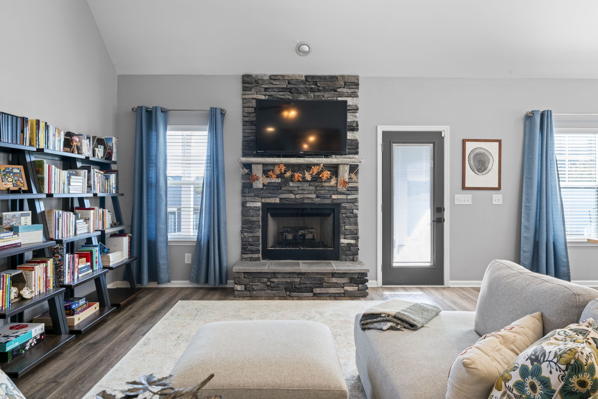 100 East Coker Way Spring Hill, TN 37174 - Photo 9 of 51 a living room with furniture a flat screen tv and a fireplace