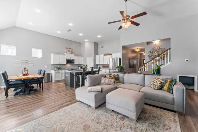 a living room with furniture kitchen view and a dining table