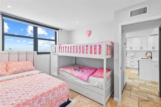 a bedroom with a bed and a couch