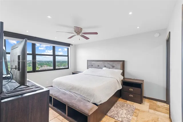 a bedroom with a large bed and a window