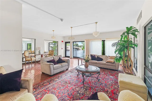 a living room with furniture potted plant and a window