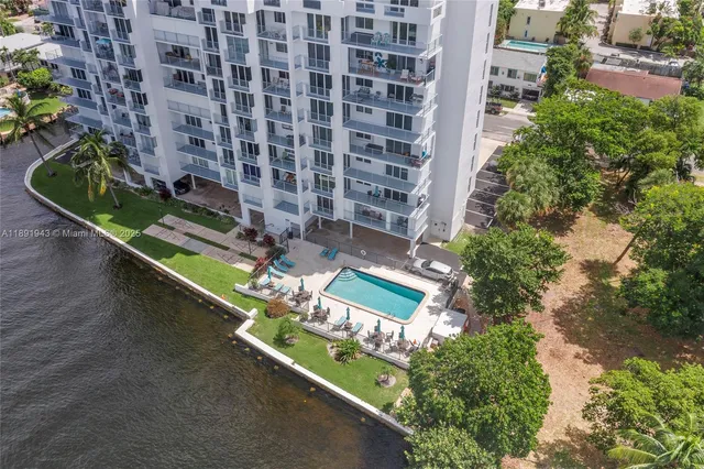 an aerial view of a house with a garden and lake view