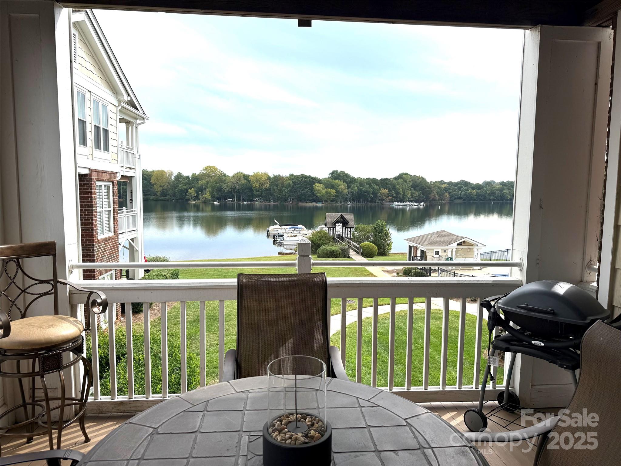 a view of a lake from a balcony with outdoor space