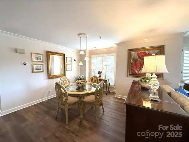 a view of a a dining room with furniture and wooden floor