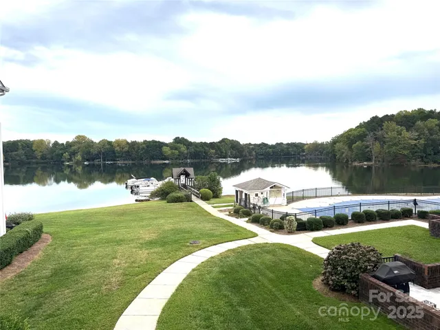 a view of a lake with houses in the back