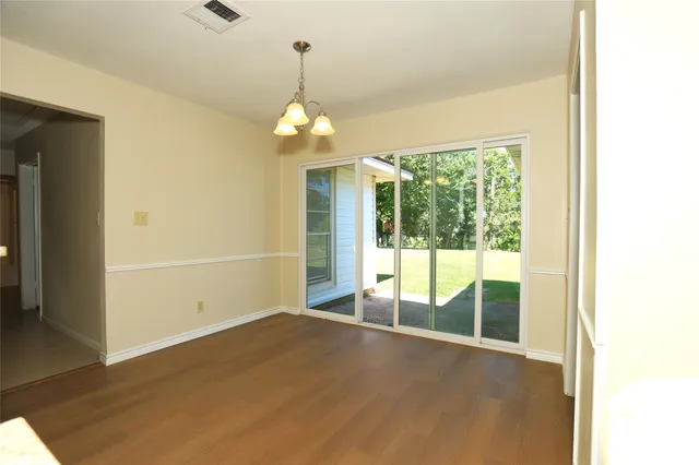 a view of empty room with floor to ceiling window