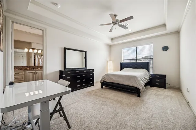 a bathroom with a granite countertop sink mirror vanity and toilet