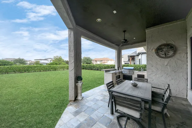 an aerial view of a house with a yard and outdoor seating