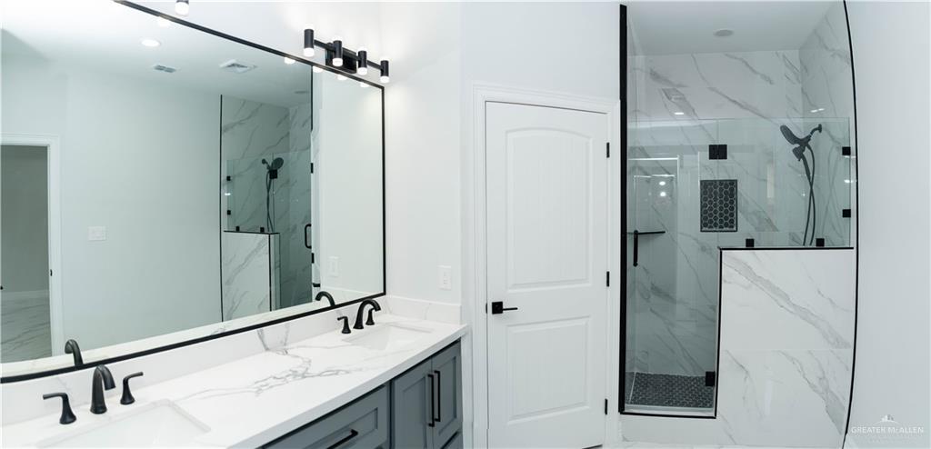 512 Spring Drive Alton, TX 78573 - Photo 11 of 18 a bathroom with a double vanity sink and mirror