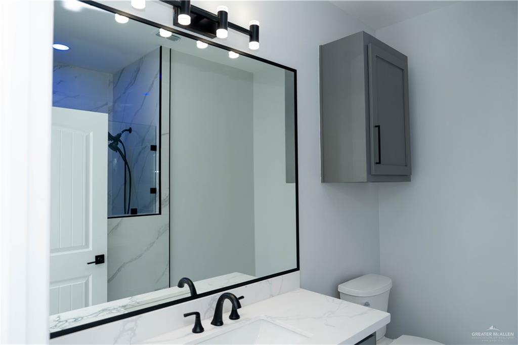 512 Spring Drive Alton, TX 78573 - Photo 13 of 18 a bathroom with a sink and mirror