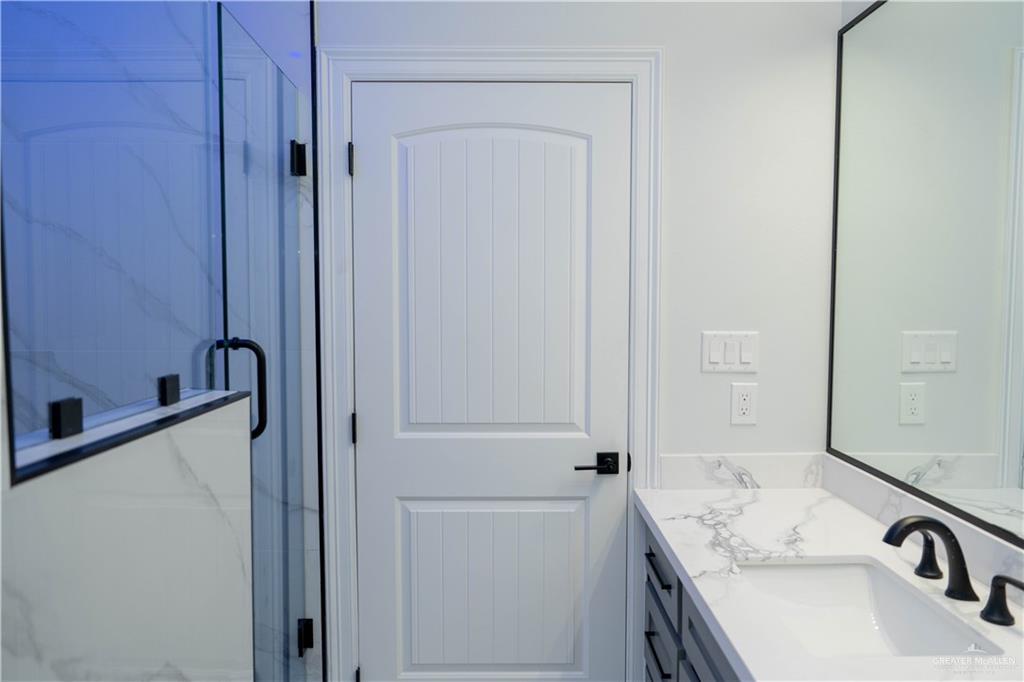 512 Spring Drive Alton, TX 78573 - Photo 14 of 18 a bathroom with a sink and a mirror