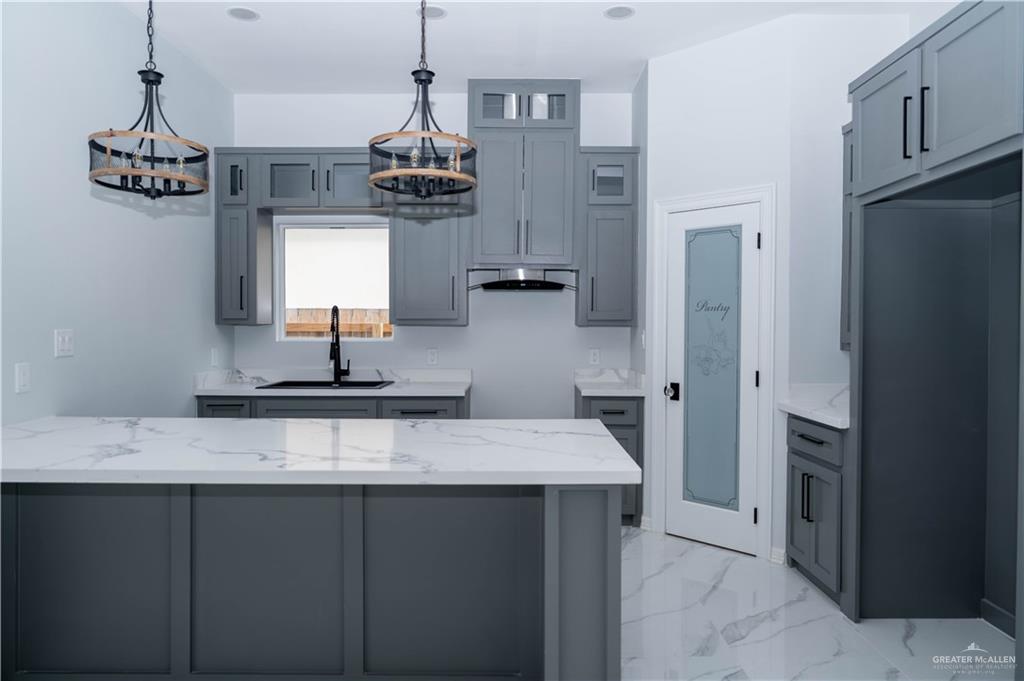 512 Spring Drive Alton, TX 78573 - Photo 4 of 18 a kitchen with kitchen island granite countertop a sink and refrigerator