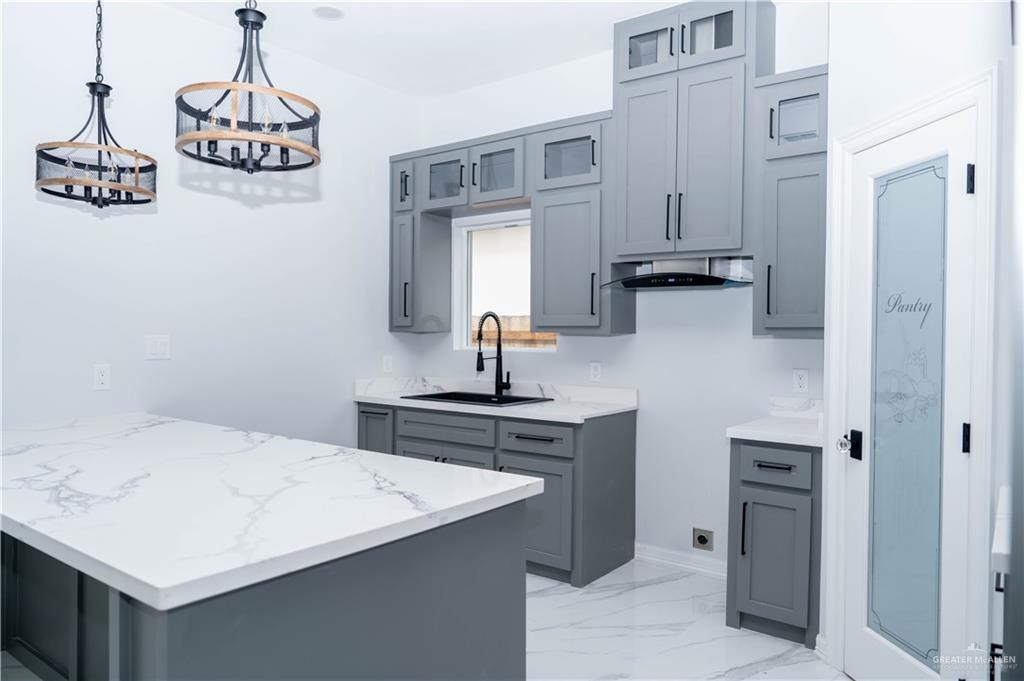 512 Spring Drive Alton, TX 78573 - Photo 5 of 18 a kitchen with stainless steel appliances a sink and a refrigerator