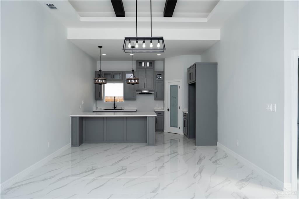 512 Spring Drive Alton, TX 78573 - Photo 6 of 18 a view of a kitchen with a sink and refrigerator