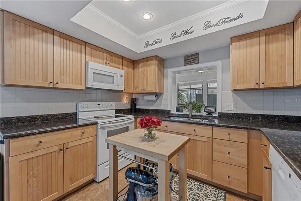 a kitchen with stainless steel appliances granite countertop a sink stove and cabinets