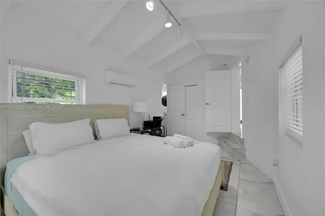 a bedroom with a bed and a couch
