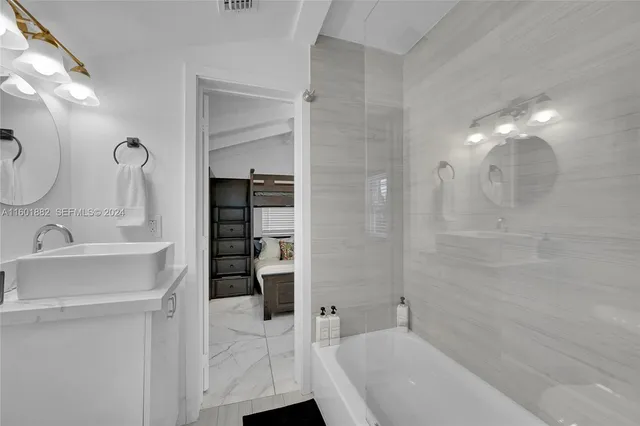 a bathroom with a bathtub and a sink