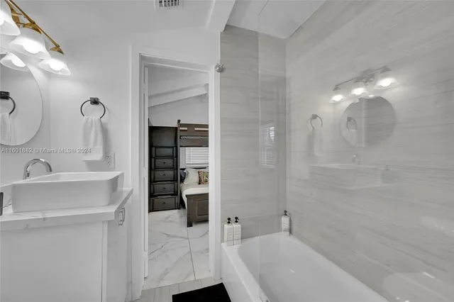 a bathroom with a bathtub and a sink