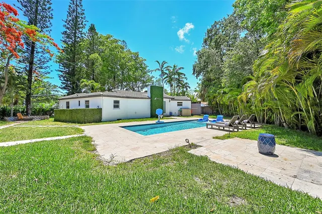 a front view of a house with yard and green space