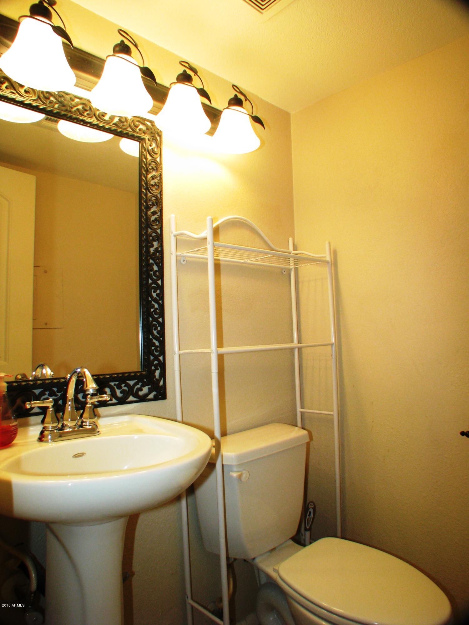 3807 North 30th Street, Unit 8 Phoenix, AZ 85016 - Photo 12 of 24 a bathroom with a sink mirror and toilet