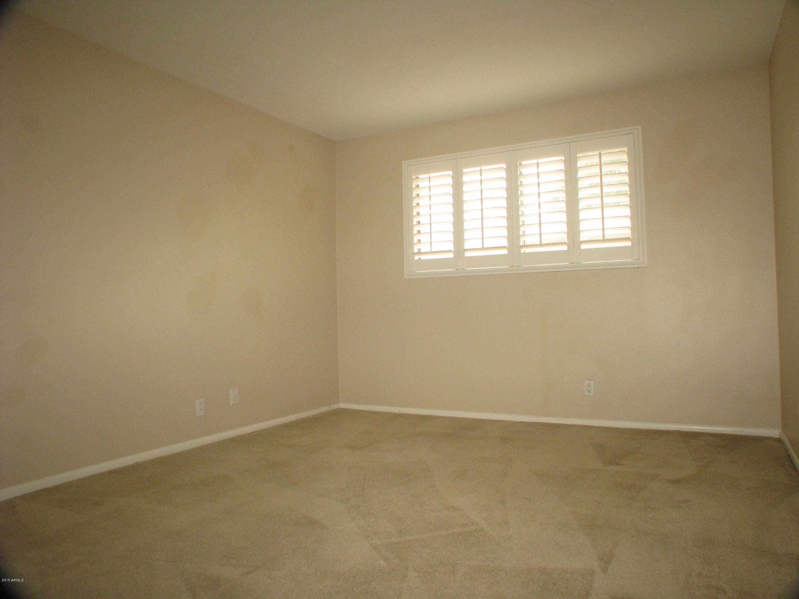 3807 North 30th Street, Unit 8 Phoenix, AZ 85016 - Photo 13 of 24 an empty room with a window