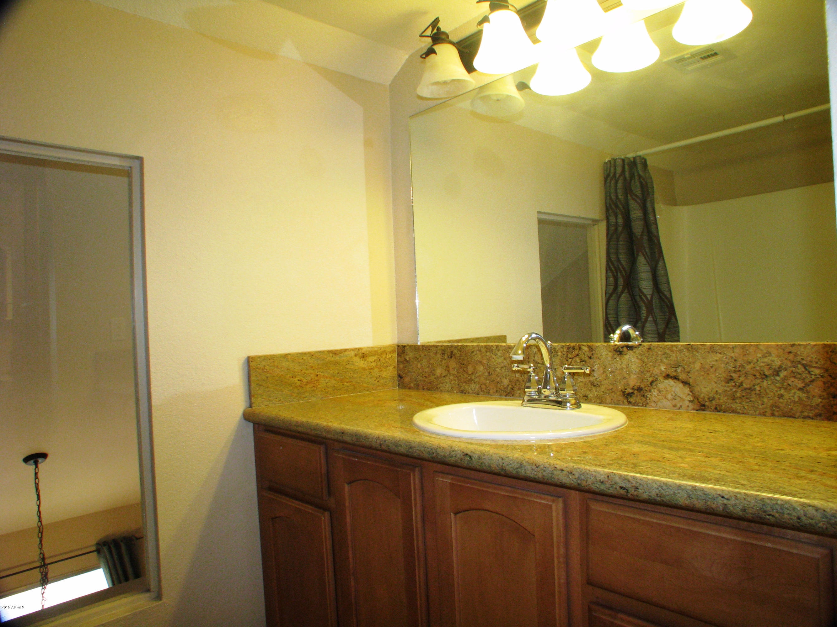 3807 North 30th Street, Unit 8 Phoenix, AZ 85016 - Photo 18 of 24 a bathroom with a granite countertop sink and a mirror