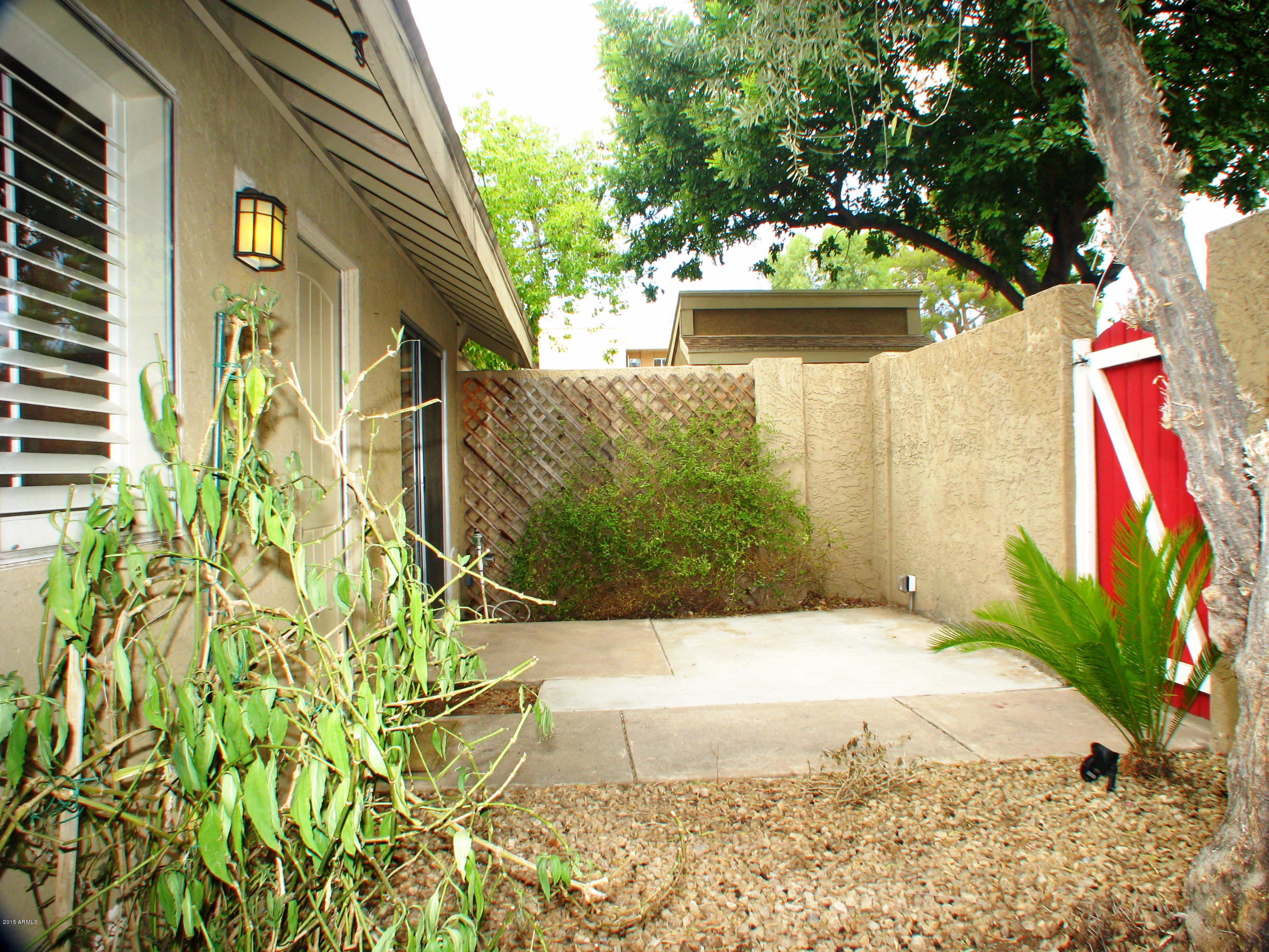 3807 North 30th Street, Unit 8 Phoenix, AZ 85016 - Photo 22 of 24 a view of yellow house with large trees