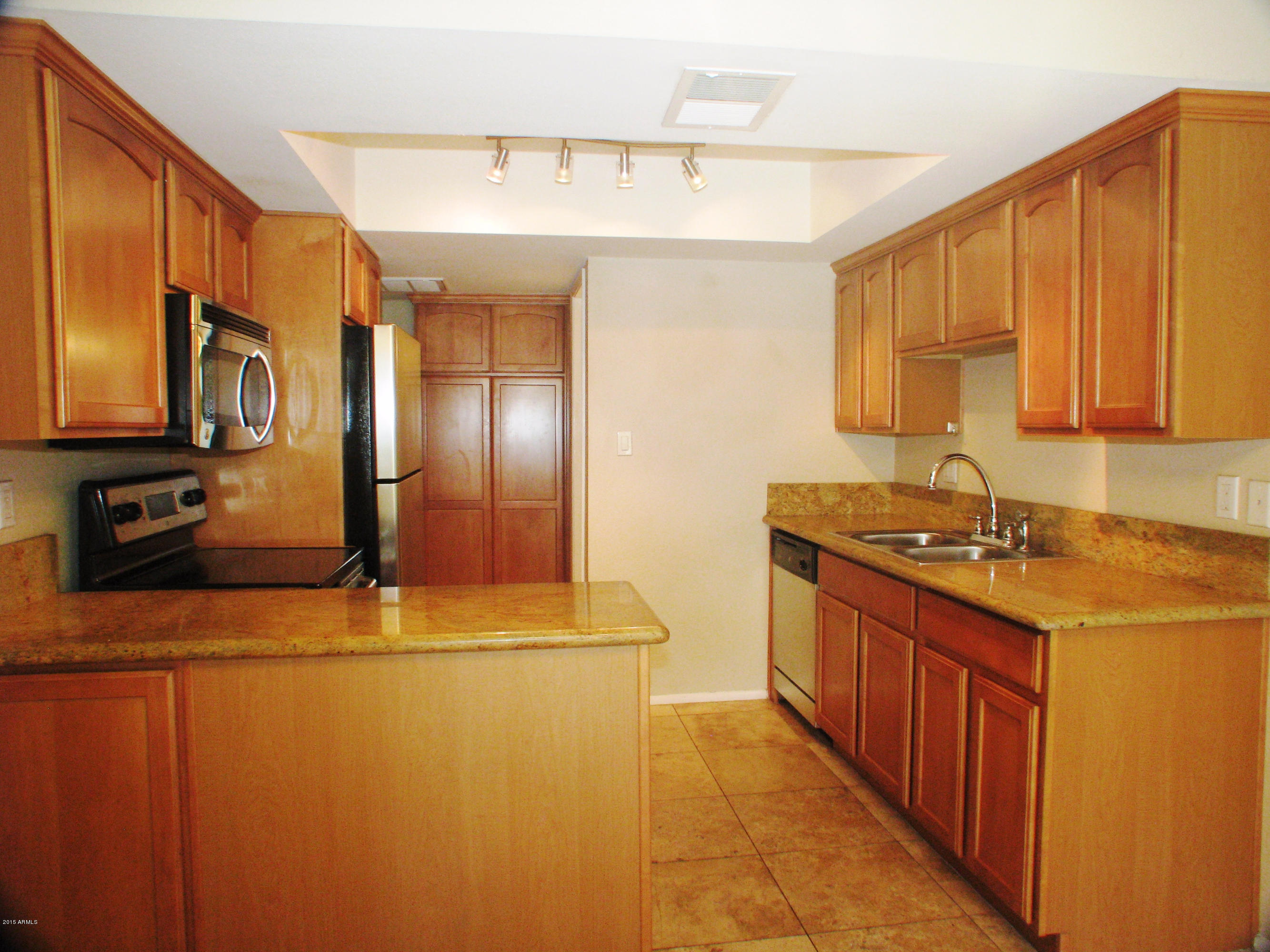 3807 North 30th Street, Unit 8 Phoenix, AZ 85016 - Photo 4 of 24 a kitchen with stainless steel appliances granite countertop a sink a stove and a refrigerator