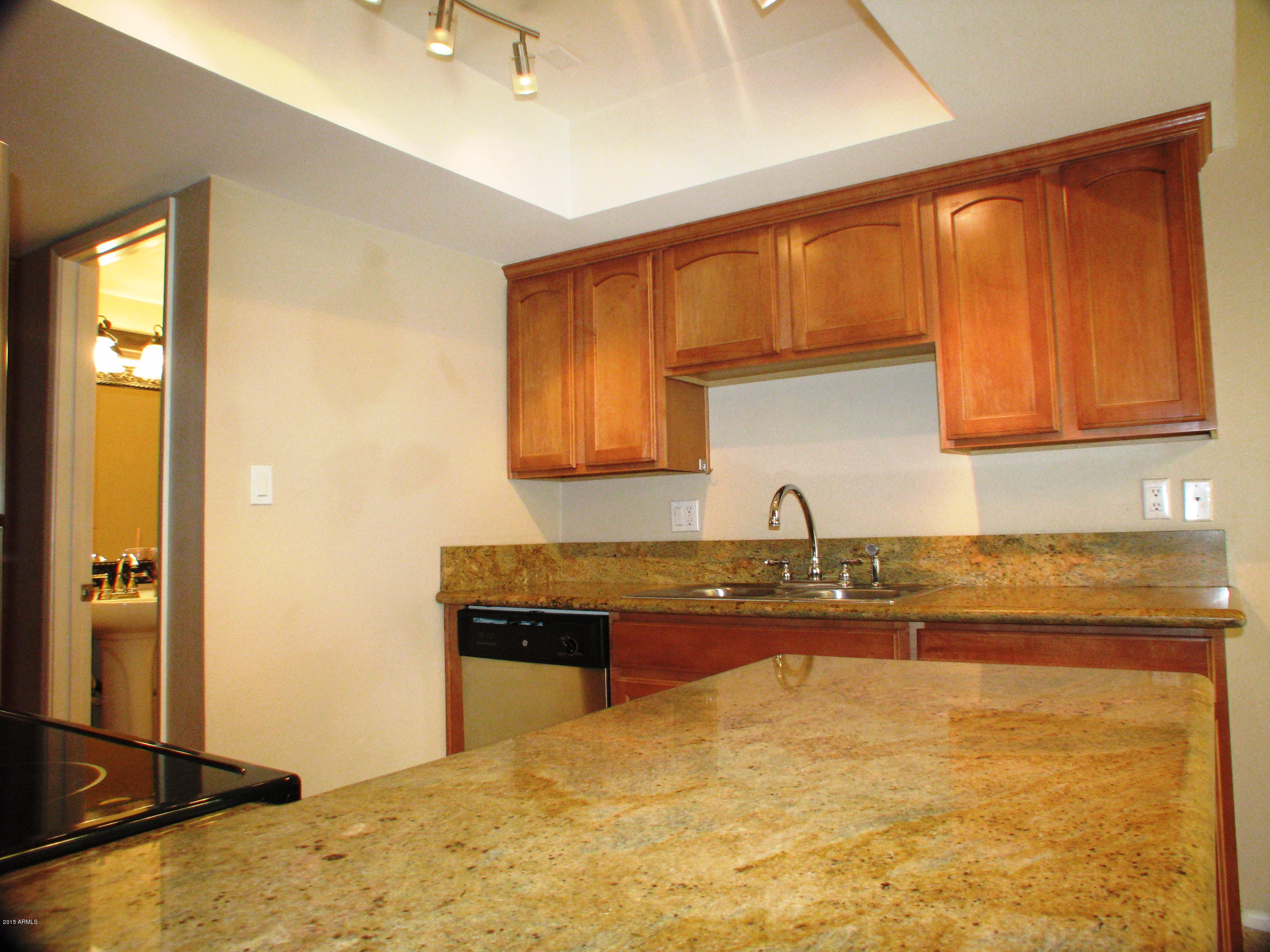 3807 North 30th Street, Unit 8 Phoenix, AZ 85016 - Photo 6 of 24 a kitchen with stainless steel appliances granite countertop a sink and cabinets