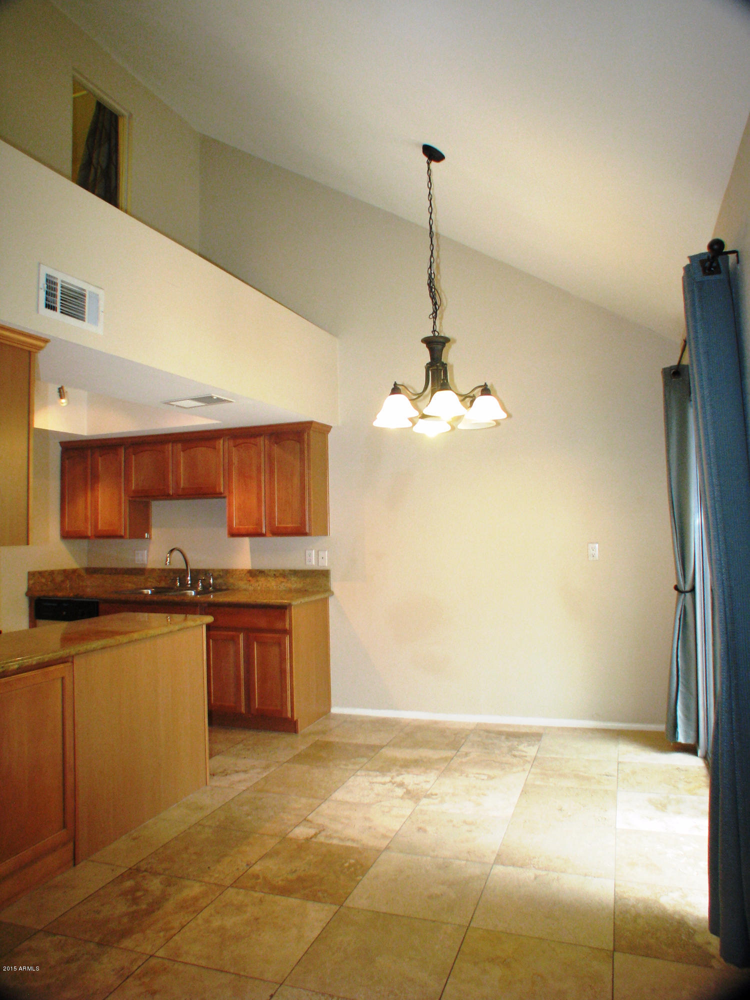3807 North 30th Street, Unit 8 Phoenix, AZ 85016 - Photo 10 of 24 a view of a kitchen with a sink wooden cabinets and a refrigerator