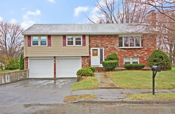 4 Thistle Road Woburn, MA 01801 - Photo 1 of 24 a front view of a house with a yard and garage