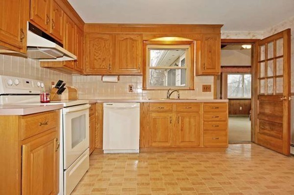 4 Thistle Road Woburn, MA 01801 - Photo 11 of 24 a kitchen with stainless steel appliances granite countertop a stove a sink and a refrigerator