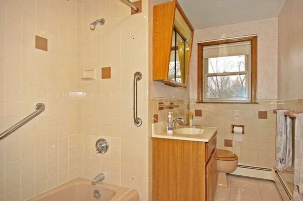 4 Thistle Road Woburn, MA 01801 - Photo 19 of 24 a bathroom with a granite countertop sink a toilet and shower