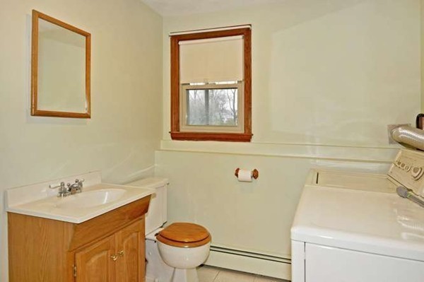 4 Thistle Road Woburn, MA 01801 - Photo 22 of 24 a bathroom with a sink toilet and vanity