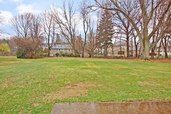 4 Thistle Road Woburn, MA 01801 - Photo 4 of 24 a backyard of apartments with large trees
