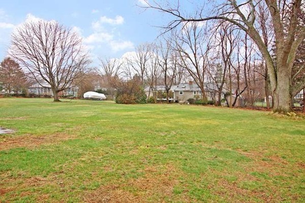 4 Thistle Road Woburn, MA 01801 - Photo 5 of 24 a view of a field with trees in the background