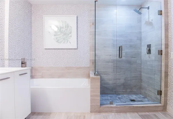 a bathroom with a bathtub and a shower