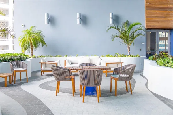 a view of a dining room with furniture and a potted plant