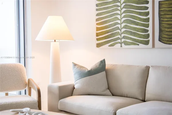 a living room with furniture and white cabinet