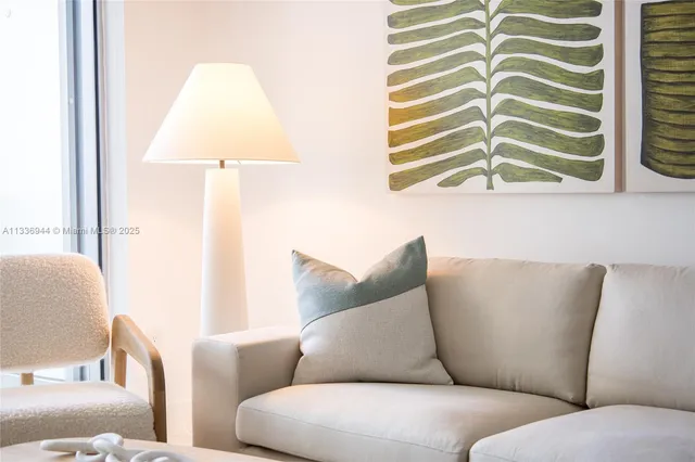 a living room with furniture and white cabinet