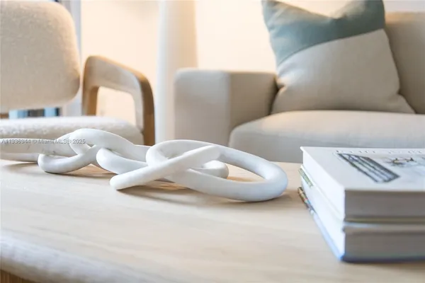 a white kitchen with a sink and a table