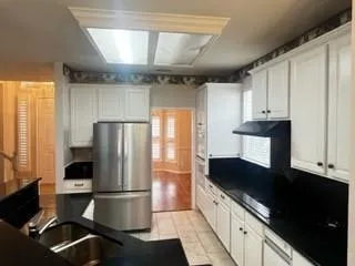 a kitchen with stainless steel appliances a refrigerator sink and cabinets