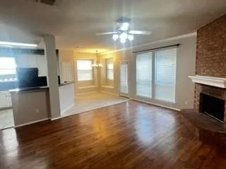 a view of a kitchen with a sink wooden cabinet and a fireplace