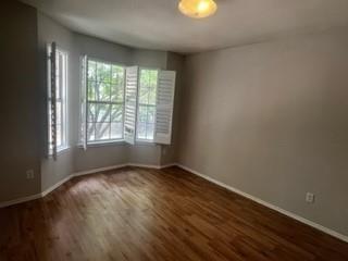 415 Colony Drive Allen, TX 75013 - Photo 9 of 14 an empty room with wooden floor and windows