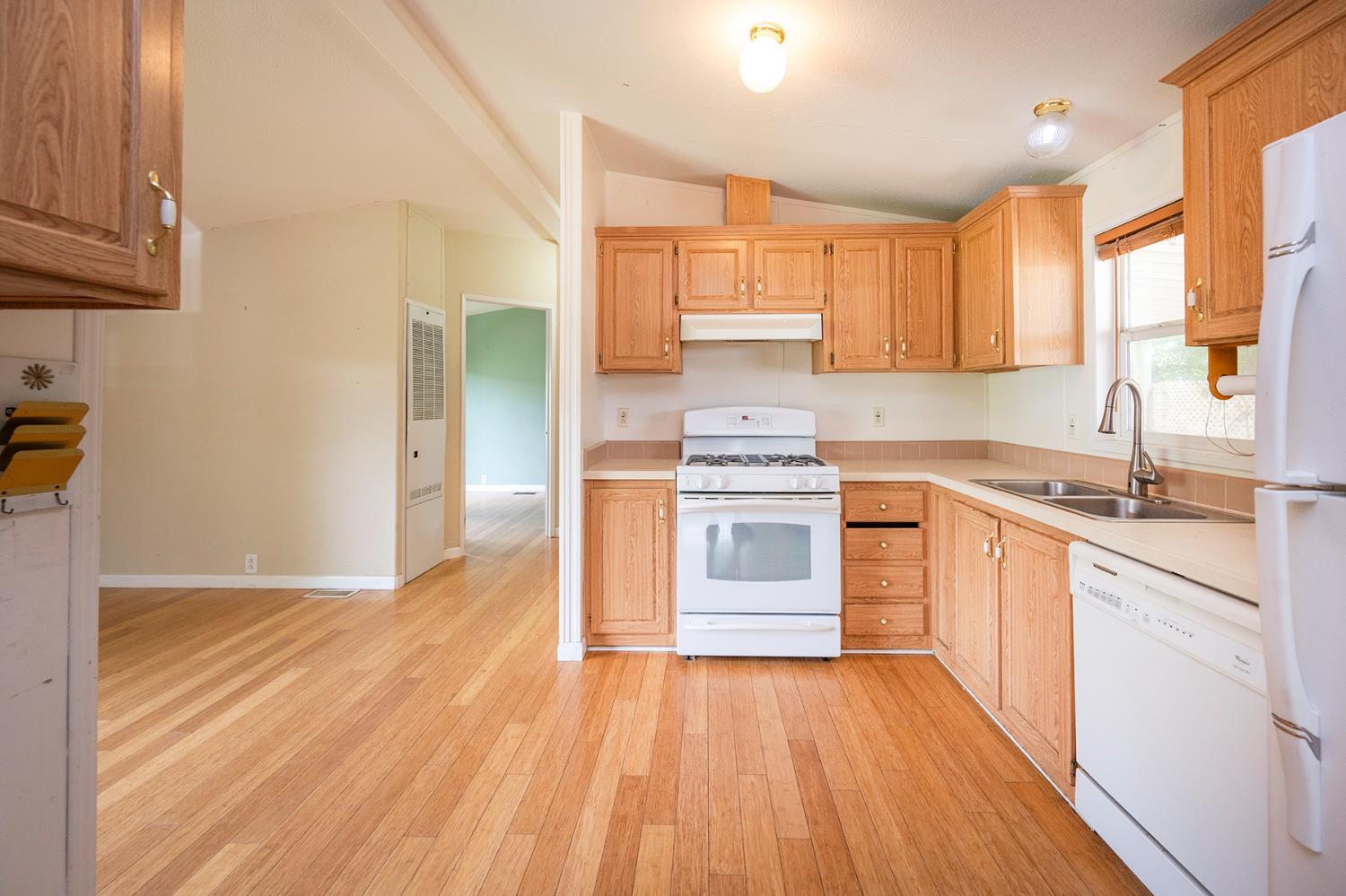 132 Danielle Way Folsom, CA 95630 - Photo 23 of 52 a kitchen with stainless steel appliances a stove top oven a sink dishwasher and a refrigerator with wooden floor