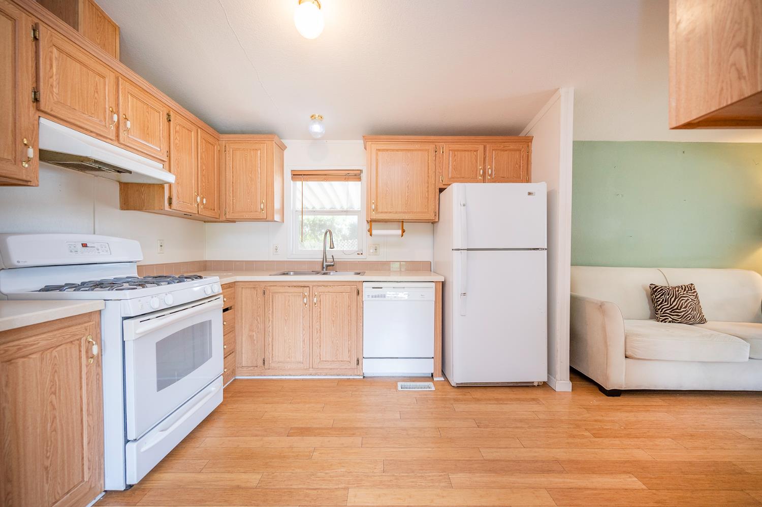 132 Danielle Way Folsom, CA 95630 - Photo 24 of 52 a kitchen with white cabinets and white appliances